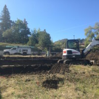 Large stepped house pad, utilities, backfilling in Ashland